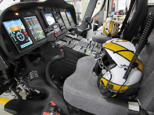 Cockpit of a helicopter with helmets on the seats