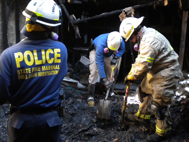 Fire Investigators digging at the scene of a fire